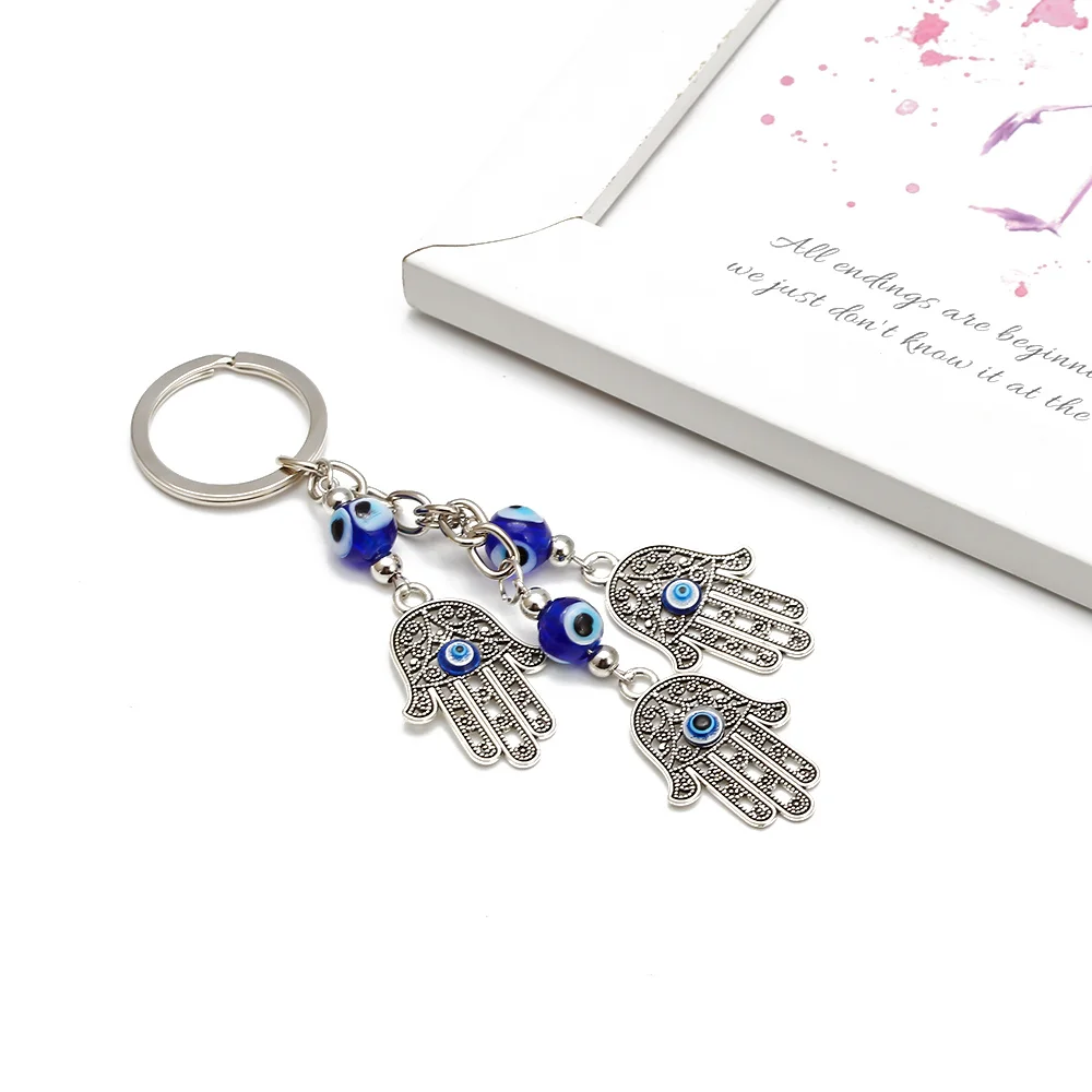 GRAPES new fashion blue evil eye Hamsa hand keychain trendy material material Hamsa keychain for woman man eye keychain
GRAPES new fashion blue evil eye Hamsa hand keychain trendy material material Hamsa keychain for woman man eye keychain