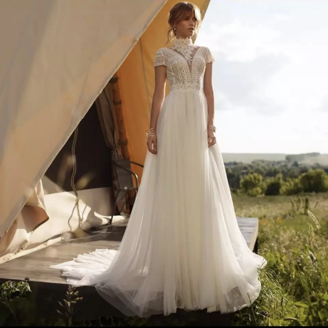 Bohemian Wedding Dress A-Line High Neck Cap Sleeve Chiffon Lace Appliques Backless Floor Length Sweep Train Bride Gown 2021
Bohemian Wedding Dress A-Line High Neck Cap Sleeve Chiffon Lace Appliques Backless Floor Length Sweep Train Bride Gown 2021