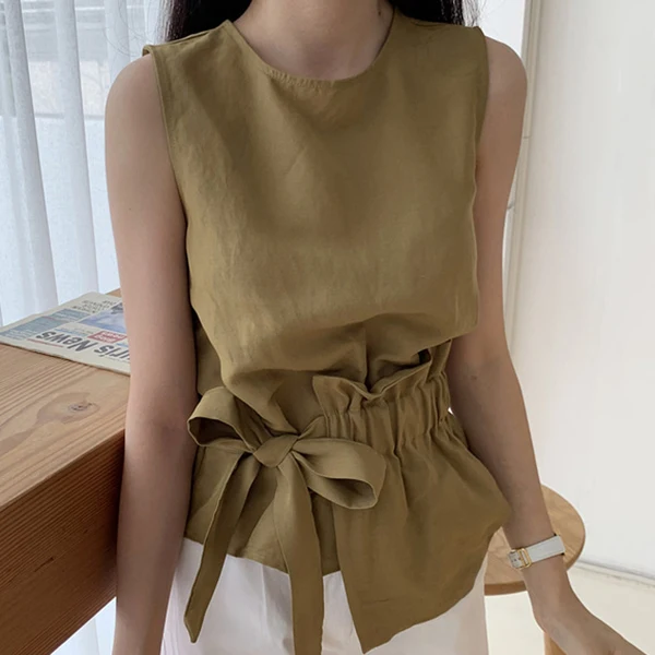 Korean chic simple versatile round neck design irregular hem waist tie bow sleeveless shirt
Korean chic simple versatile round neck design irregular hem waist tie bow sleeveless shirt