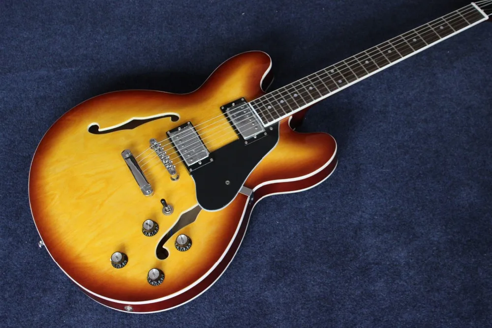 Custom shop.F hollow body jazz electric Guitar.honey color guitarra .black pickguard.Sunburst Jazz gitaar.
Custom shop.F hollow body jazz electric Guitar.honey color guitarra .black pickguard.Sunburst Jazz gitaar.