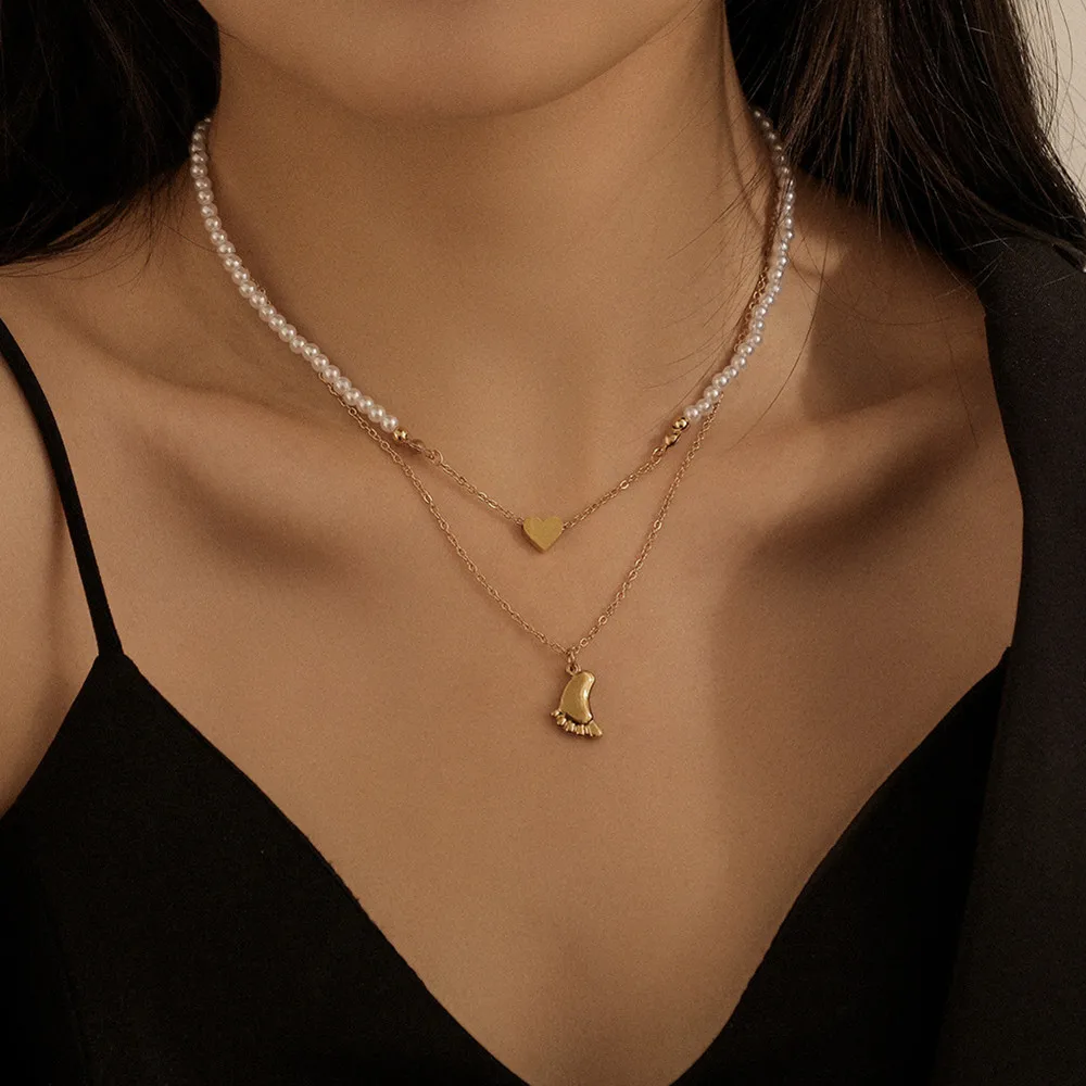 Stainless steel plated gold double necklace foot heart pendant cool wind heart pearl titanium steel clavicle chain
Stainless steel plated gold double necklace foot heart pendant cool wind heart pearl titanium steel clavicle chain