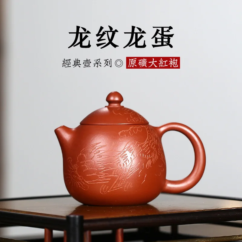 Yixing raw ore Dahongpao famous hand-made dragon pattern dragon egg purple sand pot set tea set
Yixing raw ore Dahongpao famous hand-made dragon pattern dragon egg purple sand pot set tea set