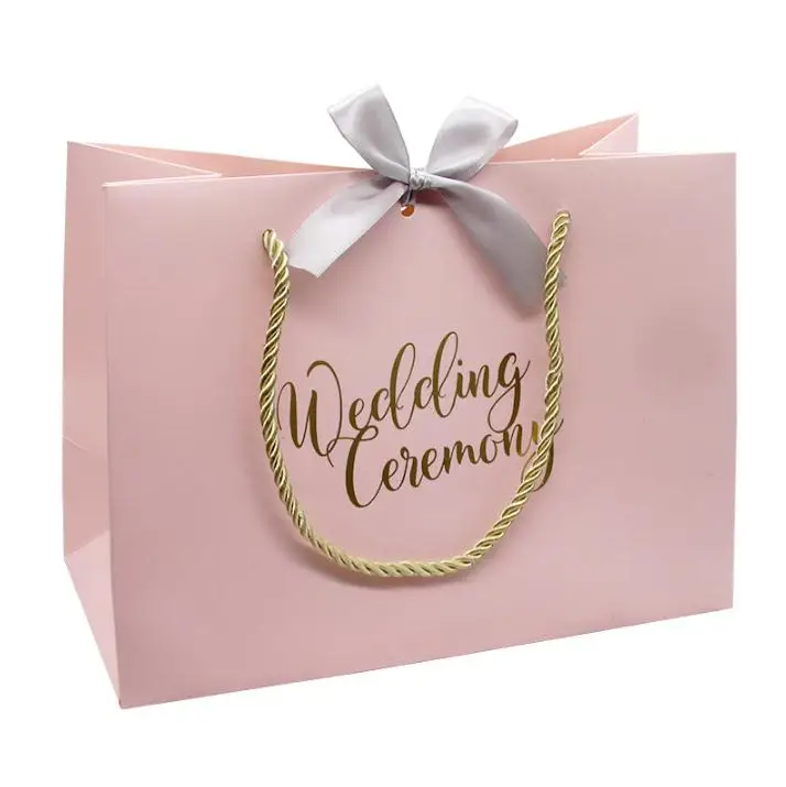 100pcs High-quality Gifts Bow Gift Bag Portable Paper Bag Wedding Supplies Tote Bag Wrapping Paper Bags with Handle Wholesale 
100pcs High-quality Gifts Bow Gift Bag Portable Paper Bag Wedding Supplies Tote Bag Wrapping Paper Bags with Handle Wholesale
