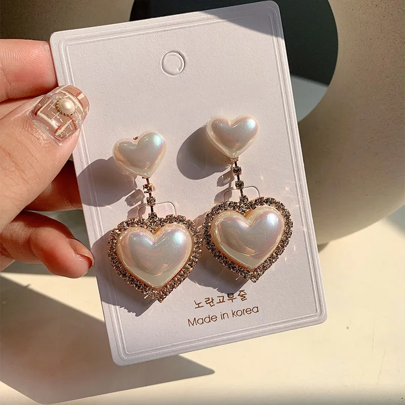 MENGJIQIAO New Korean Elegant Love Heart Pearl Dangle Pendientes For Women Fashion Accessories Rhinestone Drop Boucle D'oreille
MENGJIQIAO New Korean Elegant Love Heart Pearl Dangle Pendientes For Women Fashion Accessories Rhinestone Drop Boucle D'oreille