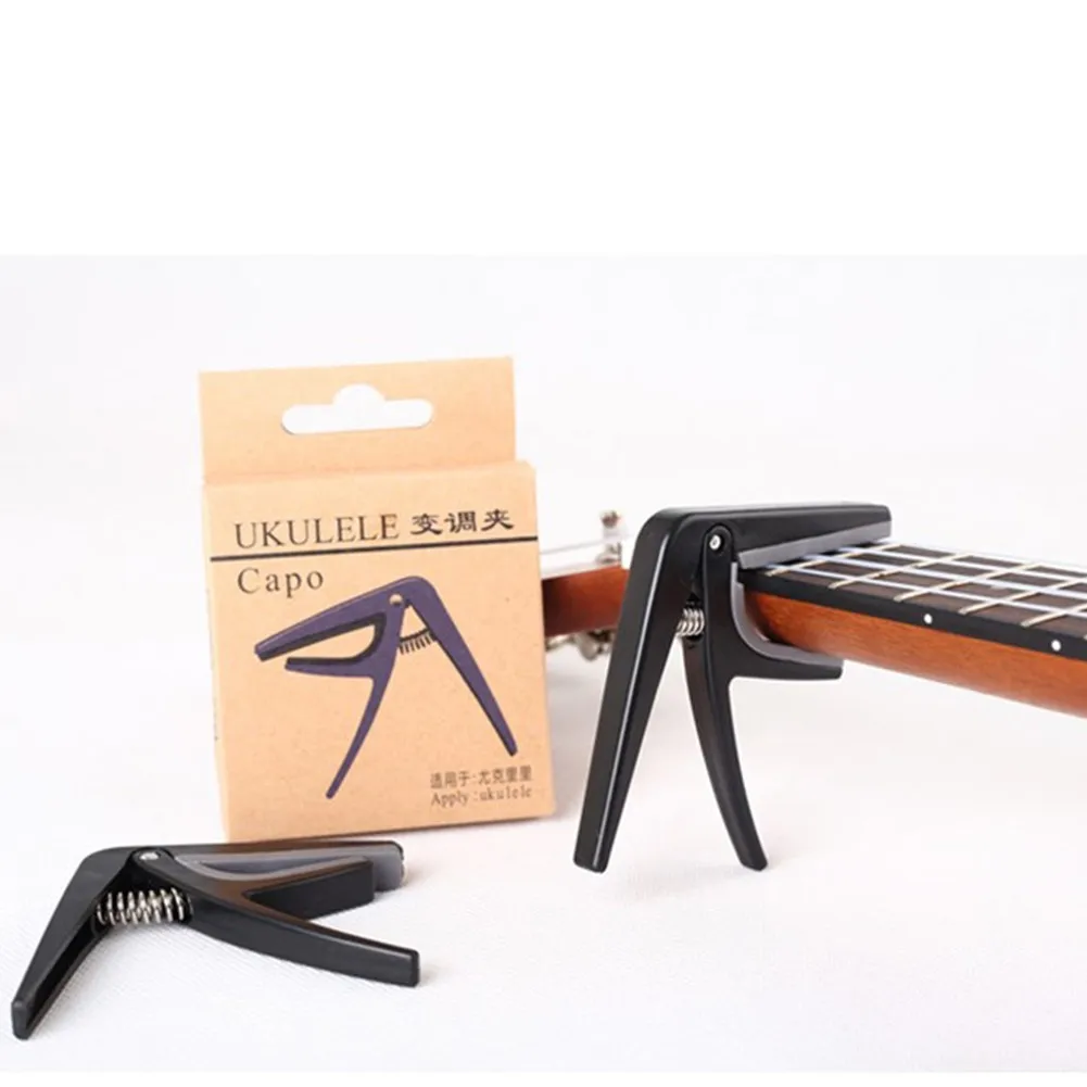 Professional Ukulele Capo 4 String Hawaii Guitar Tuning Clamp Quick Change Black Ukulele Tuning Part Stringed Instrument Equip
Professional Ukulele Capo 4 String Hawaii Guitar Tuning Clamp Quick Change Black Ukulele Tuning Part Stringed Instrument Equip