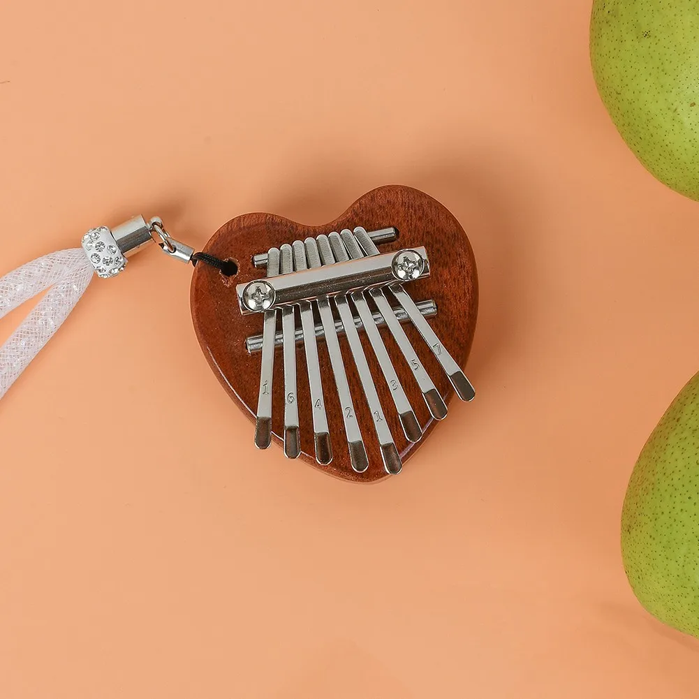 Heart-shaped Mahogany-wood Mini 8-tone Thumb Piano Kalimba Backpack Decoration + Lanyard Christmans Musical Instrument Gift
Heart-shaped Mahogany-wood Mini 8-tone Thumb Piano Kalimba Backpack Decoration + Lanyard Christmans Musical Instrument Gift