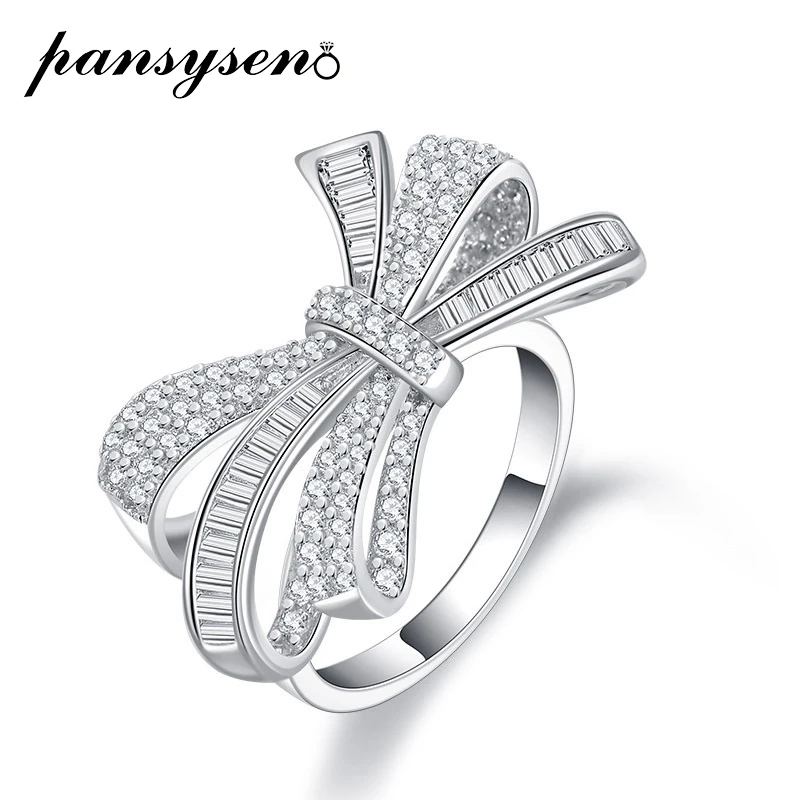 PANSYSEN Classic Bowknot Design 100% 925 Sterling Silver Created Moissanite Diamond Gemstone Anniversary Fine Jewelry Ring Gift
PANSYSEN Classic Bowknot Design 100% 925 Sterling Silver Created Moissanite Diamond Gemstone Anniversary Fine Jewelry Ring Gift