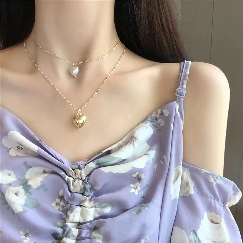 Popular contracted temperament ins cold wind double metal peach heart girl collarbone chain pearl necklace 
Popular contracted temperament ins cold wind double metal peach heart girl collarbone chain pearl necklace
