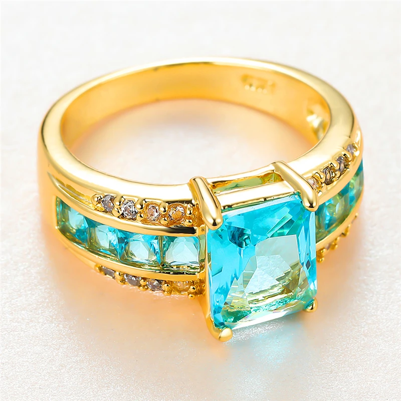 Vintage Female Aqua Blue Crystal Ring Charm Gold Color Thin Wedding Rings For Women Luxury Bride Square Zircon Engagement Ring
Vintage Female Aqua Blue Crystal Ring Charm Gold Color Thin Wedding Rings For Women Luxury Bride Square Zircon Engagement Ring