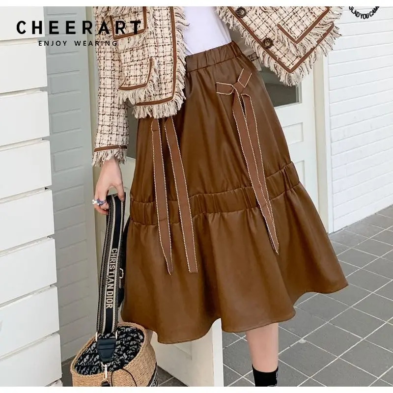 CHEERART Preppy Style Brown Pu Leather High Waisted Skirt Women 2021 Fall Korean Fashion Bow Tie Ruffles Knee Length Skirt
CHEERART Preppy Style Brown Pu Leather High Waisted Skirt Women 2021 Fall Korean Fashion Bow Tie Ruffles Knee Length Skirt