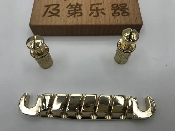 ibz jazz guitar bridge quick changes LP Tune-O-Matic Roller Saddle in golden color new and original
ibz jazz guitar bridge quick changes LP Tune-O-Matic Roller Saddle in golden color new and original
