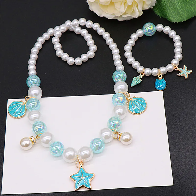 Children's Pearl Necklace Bracelet 2/5pcs Set Love Stars Shell Ocean Series Princess Accessories Dazzling Pink Colored Beads Set
Children's Pearl Necklace Bracelet 2/5pcs Set Love Stars Shell Ocean Series Princess Accessories Dazzling Pink Colored Beads Set