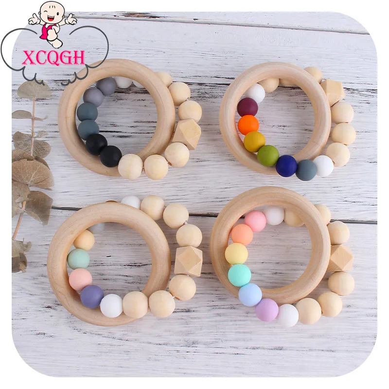 XCQGH 1Pcs Wooden Ring Silicone Teething Bracelet Multicolor Kids Baby Rattle Nursing Teether Toy Chew Product
XCQGH 1Pcs Wooden Ring Silicone Teething Bracelet Multicolor Kids Baby Rattle Nursing Teether Toy Chew Product