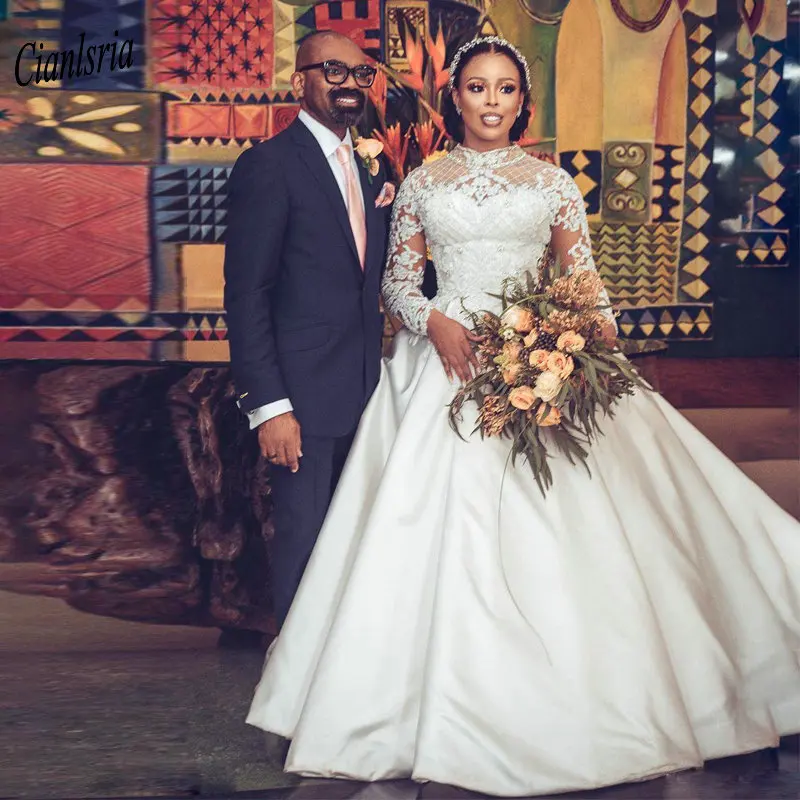 Newest High Neck Long Sleeve Nigerian African Ball Gown Wedding Dress Appliques Lace Beading Satin Bridal Wedding Dresses
Newest High Neck Long Sleeve Nigerian African Ball Gown Wedding Dress Appliques Lace Beading Satin Bridal Wedding Dresses