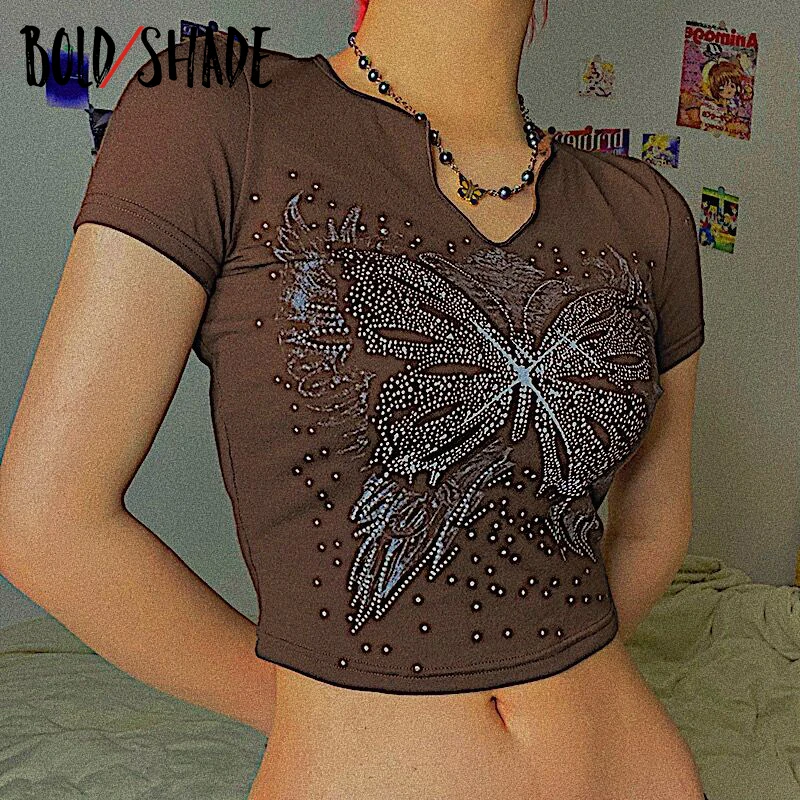 Bold Shade Goblincore Y2K Grunge Tee Shirt BUtterfly Rhinestone Short Sleeve Crewneck Slim Tops Women Indie Retro Style Crop Top
Bold Shade Goblincore Y2K Grunge Tee Shirt BUtterfly Rhinestone Short Sleeve Crewneck Slim Tops Women Indie Retro Style Crop Top