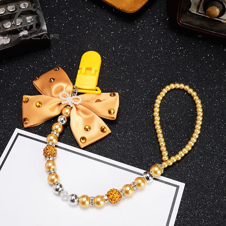 MIYOCAR Bling golden rhinestone bow gold beads Luxurious dummy clip holder pacifier clips holder/Teethers clip pacifier chain
MIYOCAR Bling golden rhinestone bow gold beads Luxurious dummy clip holder pacifier clips holder/Teethers clip pacifier chain