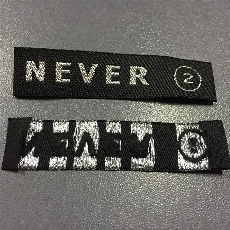 Custom-Made 1.5*6.5cm High Density Silver Letters Woven Labels Clothing Labels
Custom-Made 1.5*6.5cm High Density Silver Letters Woven Labels Clothing Labels