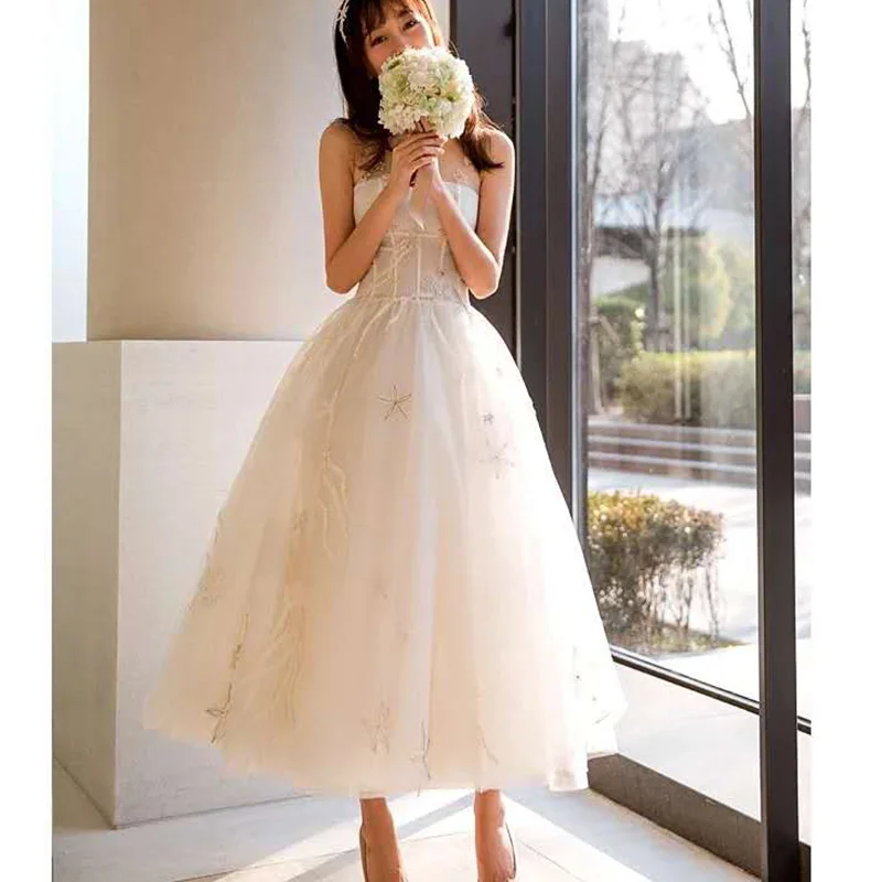 Charming modern ankle long champagne tulle strapless illusion neckline Bridal ball Gowns Wedding Dresses 2019 with star pattern
Charming modern ankle long champagne tulle strapless illusion neckline Bridal ball Gowns Wedding Dresses 2019 with star pattern