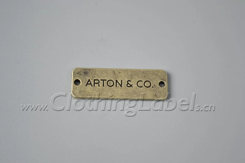 Custom metal tag labels for clothing anti brass color zinc alloy material accessories etc. engraved logo with holes at each side
Custom metal tag labels for clothing anti brass color zinc alloy material accessories etc. engraved logo with holes at each side