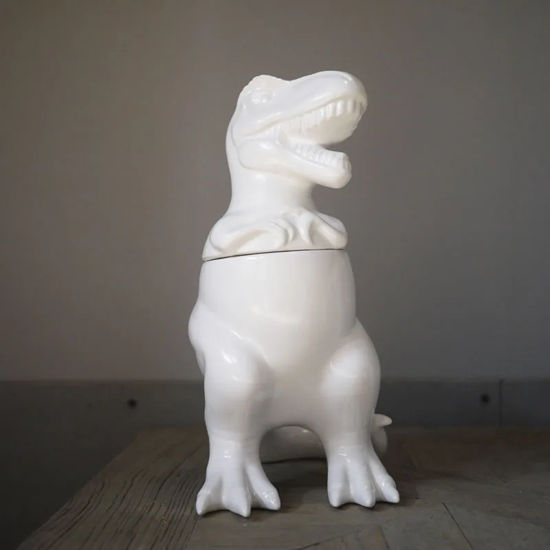 White ceramic Creative Tyrannosaurus rex storage jar home decor crafts room decoration objects vintage dinosaur Decorative cans
White ceramic Creative Tyrannosaurus rex storage jar home decor crafts room decoration objects vintage dinosaur Decorative cans
