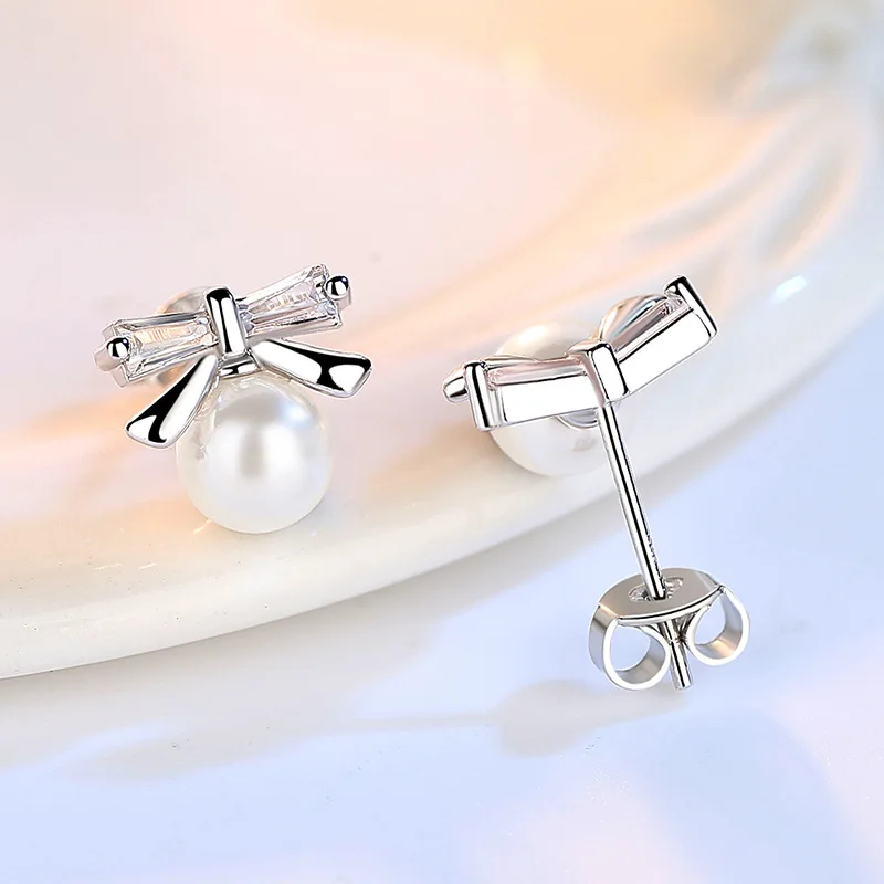 100% 925 Sterling Silver Bowknot Design Shiny Crystal Pearl Stud Earrings for Women Jewelry Wedding Gift Wholesale
100% 925 Sterling Silver Bowknot Design Shiny Crystal Pearl Stud Earrings for Women Jewelry Wedding Gift Wholesale