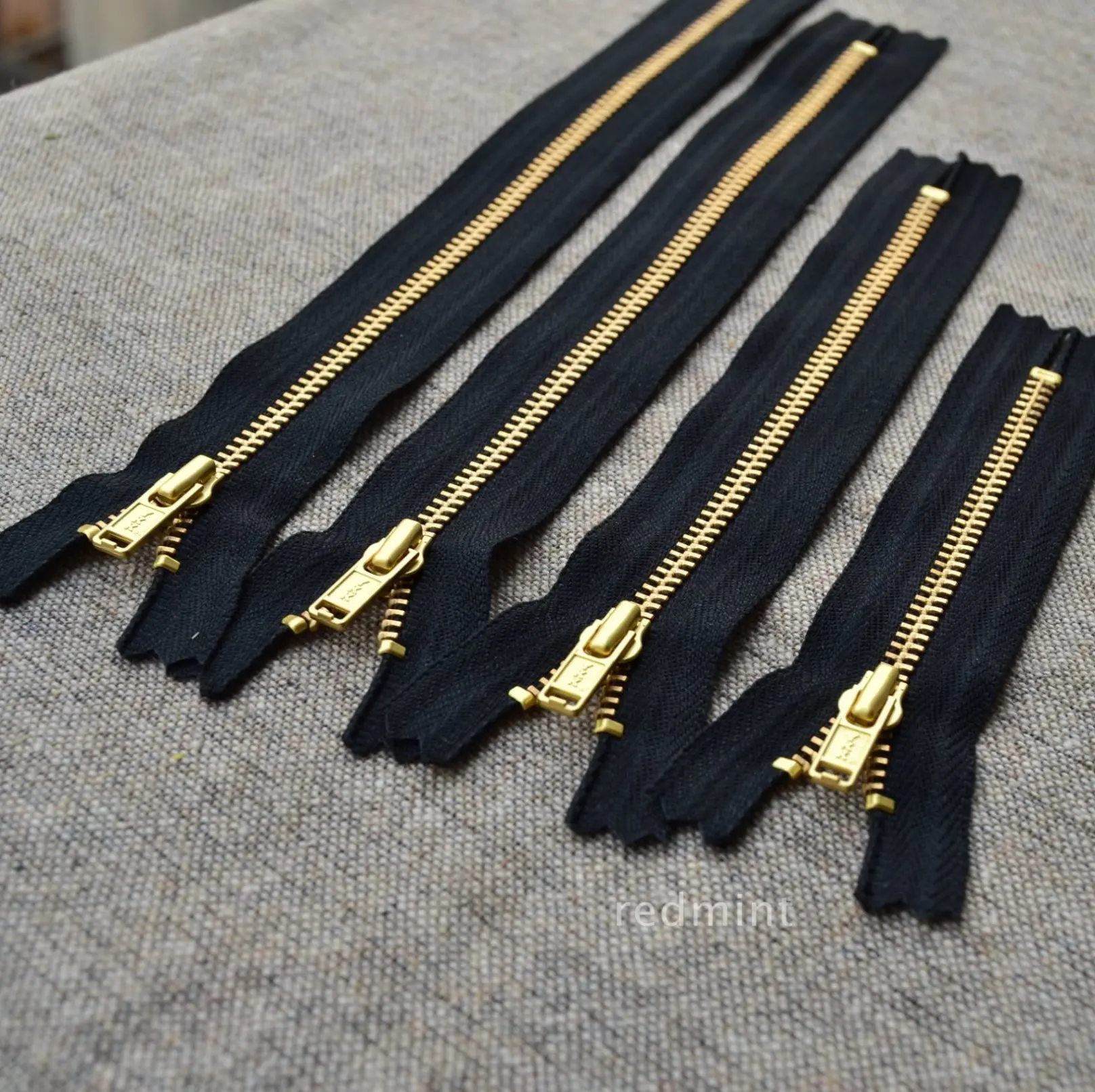 3 gold copper closed black belt YKK metal zipper bag wallet clothing with details
3 gold copper closed black belt YKK metal zipper bag wallet clothing with details