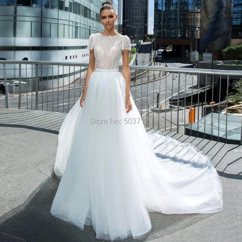 2021 Beach Tulle Mermaid Wedding Dresses Two Pieces Short Sleeves Bridal Gown with Detachable Train Backless Robe De Mariée
2021 Beach Tulle Mermaid Wedding Dresses Two Pieces Short Sleeves Bridal Gown with Detachable Train Backless Robe De Mariée