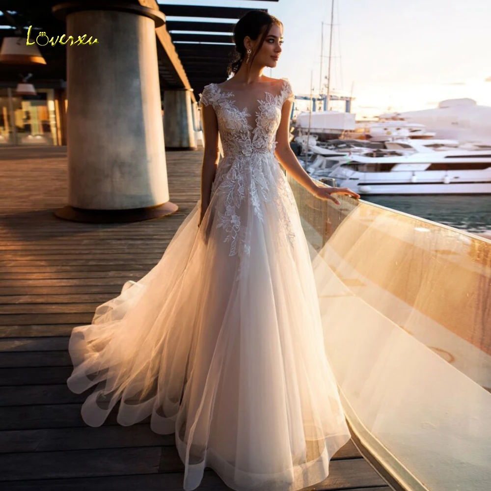 Loverxu Sexy Illusion Scoop Neck Beach Wedding Dresses 2022 Elegant Appliques Sweep Train Cap Sleeve Tulle Vintage Bridal Gowns
Loverxu Sexy Illusion Scoop Neck Beach Wedding Dresses 2022 Elegant Appliques Sweep Train Cap Sleeve Tulle Vintage Bridal Gowns