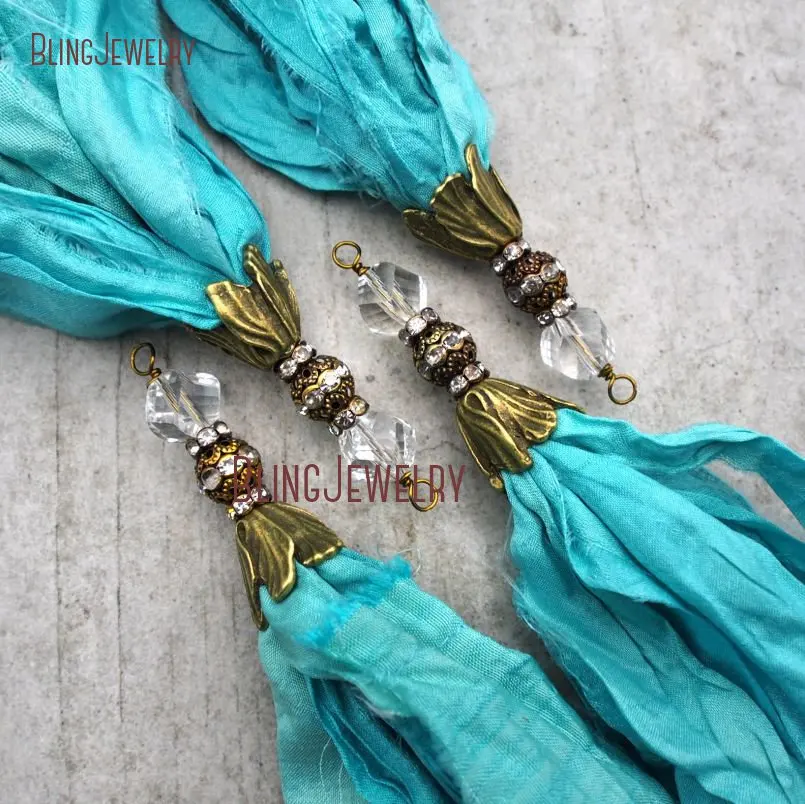 Turquoises Sari Silk Tassel Pendant Antique Bronze Cap and Crystal Accent PM9119
Turquoises Sari Silk Tassel Pendant Antique Bronze Cap and Crystal Accent PM9119