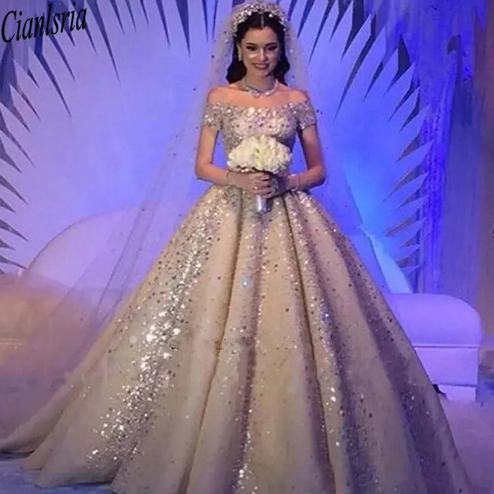 Luxurious Saudi Arabic Crystals Rhinestones Ball Gown Wedding Dresses Plus Size Dubai Off-Shoulder Beaded Chruch Bridal Gown
Luxurious Saudi Arabic Crystals Rhinestones Ball Gown Wedding Dresses Plus Size Dubai Off-Shoulder Beaded Chruch Bridal Gown