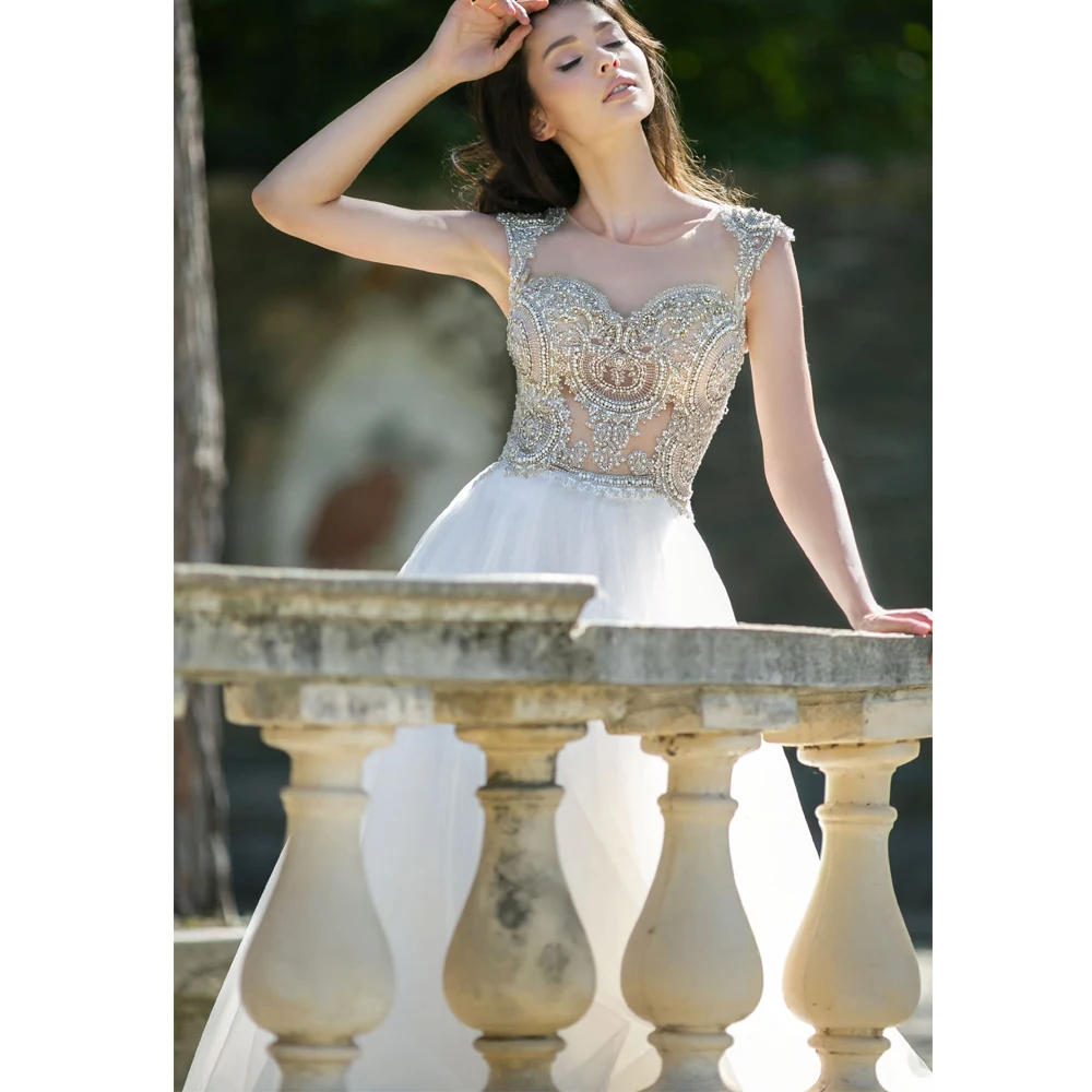 Vestidos Elegant Wedding Dresses Tulle Illusion Appliques Crystal Bateau Sleeveless Covered Button Ball Bridal Gowns
Vestidos Elegant Wedding Dresses Tulle Illusion Appliques Crystal Bateau Sleeveless Covered Button Ball Bridal Gowns