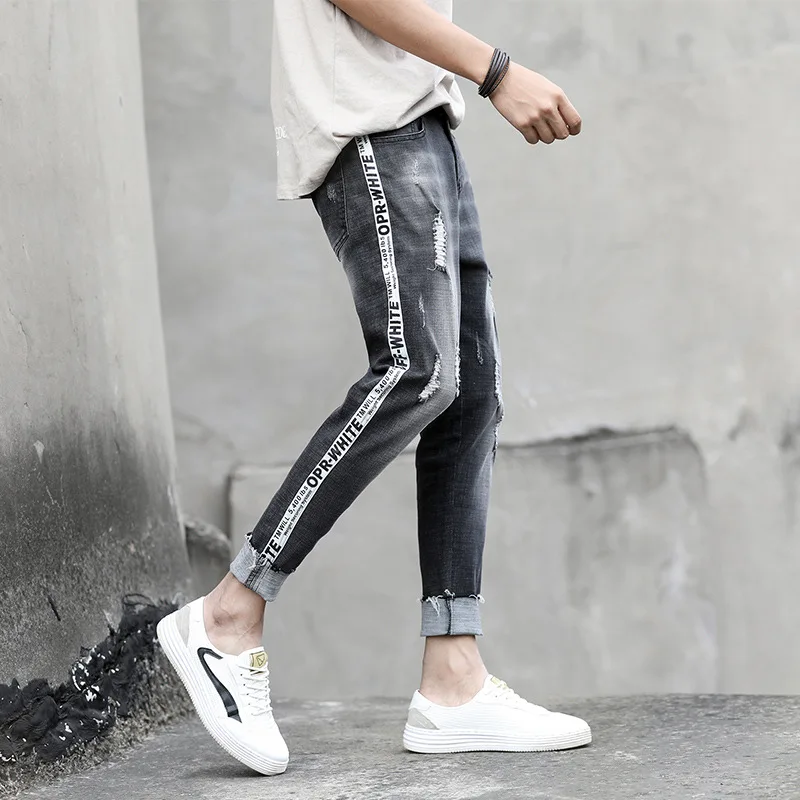 Spring summer ripped holes pencil jeans men's Korean trendy grey youth slim feet pants side striped teenagers cowboy men's pants
Spring summer ripped holes pencil jeans men's Korean trendy grey youth slim feet pants side striped teenagers cowboy men's pants