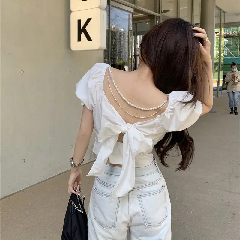 Fashion New Pearl Chain Shirt Women Summer French Bow Backless White Blouse Sweet Puff Sleeve Crop Top Female
Fashion New Pearl Chain Shirt Women Summer French Bow Backless White Blouse Sweet Puff Sleeve Crop Top Female