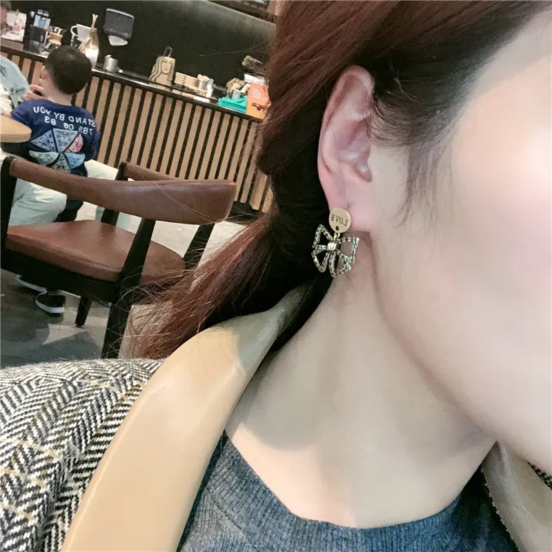 Silver Needle Korean version of the new style, fashion and old, micro-inlaid butterfly letters, hollow and simple stud earrings