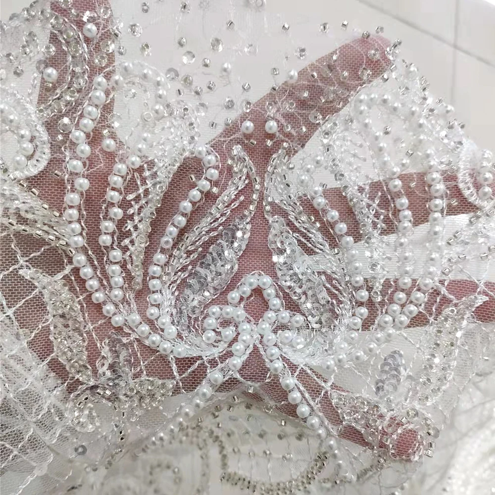 Bridal Luxury Quality Pearl Beaded White Sequin Mesh Lace Tulle Embroidery Fabric Elegant Wedding Dress Material for Sewing Gown
Bridal Luxury Quality Pearl Beaded White Sequin Mesh Lace Tulle Embroidery Fabric Elegant Wedding Dress Material for Sewing Gown