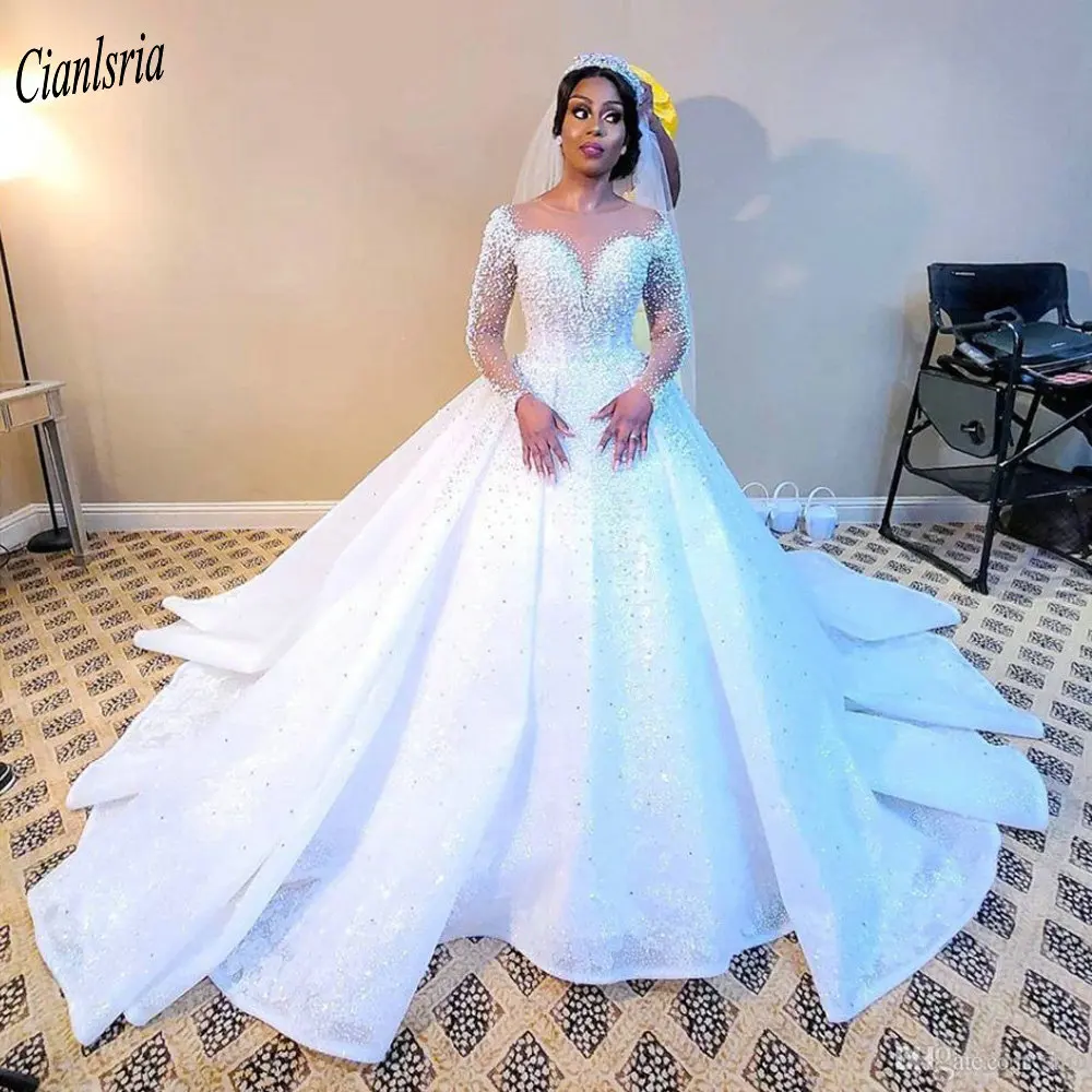 Sparkly Beading Pearls O-Neck Illusion Dubai Saudi Arabic Ball Gown Wedding Dress Long Sleeve Appliques Lace Bridal Gowns
Sparkly Beading Pearls O-Neck Illusion Dubai Saudi Arabic Ball Gown Wedding Dress Long Sleeve Appliques Lace Bridal Gowns