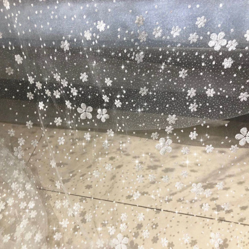 Snowflake Sequin Glitter Bronzing Flower Lace Fabric Transparent Mesh Designer DIY Wedding Dress Material Telas Por Metro Tissus
Snowflake Sequin Glitter Bronzing Flower Lace Fabric Transparent Mesh Designer DIY Wedding Dress Material Telas Por Metro Tissus