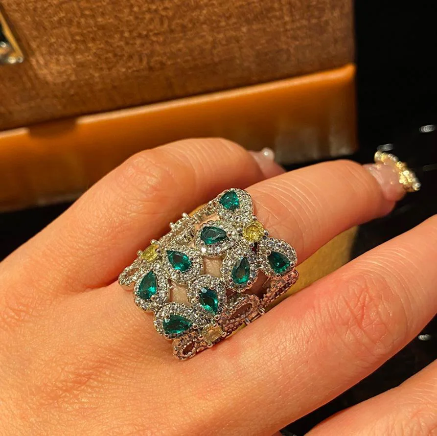 Wide green diamond flower row diamond emerald hit color zircon ring retro plant wedding luxurious summer shiny open finger ring
Wide green diamond flower row diamond emerald hit color zircon ring retro plant wedding luxurious summer shiny open finger ring