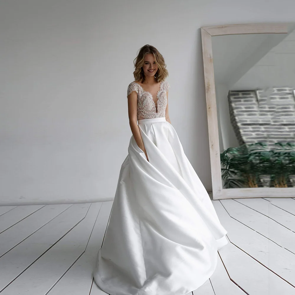 White Satin Wedding Dresses Cap Sleeve Deep V-Neck A-Line Illusion Bridal Gown 2022 Lace Button Vestido De Novia Sweep Train
White Satin Wedding Dresses Cap Sleeve Deep V-Neck A-Line Illusion Bridal Gown 2022 Lace Button Vestido De Novia Sweep Train