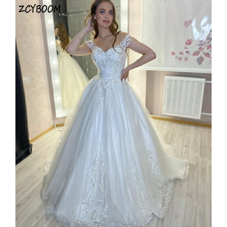 Elegant V-Neck Off The Shoulder Appliques Sleeveless White Wedding Dress 2024 Ball Gown Floor Length Sweep Train Bridal Gown
Elegant V-Neck Off The Shoulder Appliques Sleeveless White Wedding Dress 2024 Ball Gown Floor Length Sweep Train Bridal Gown