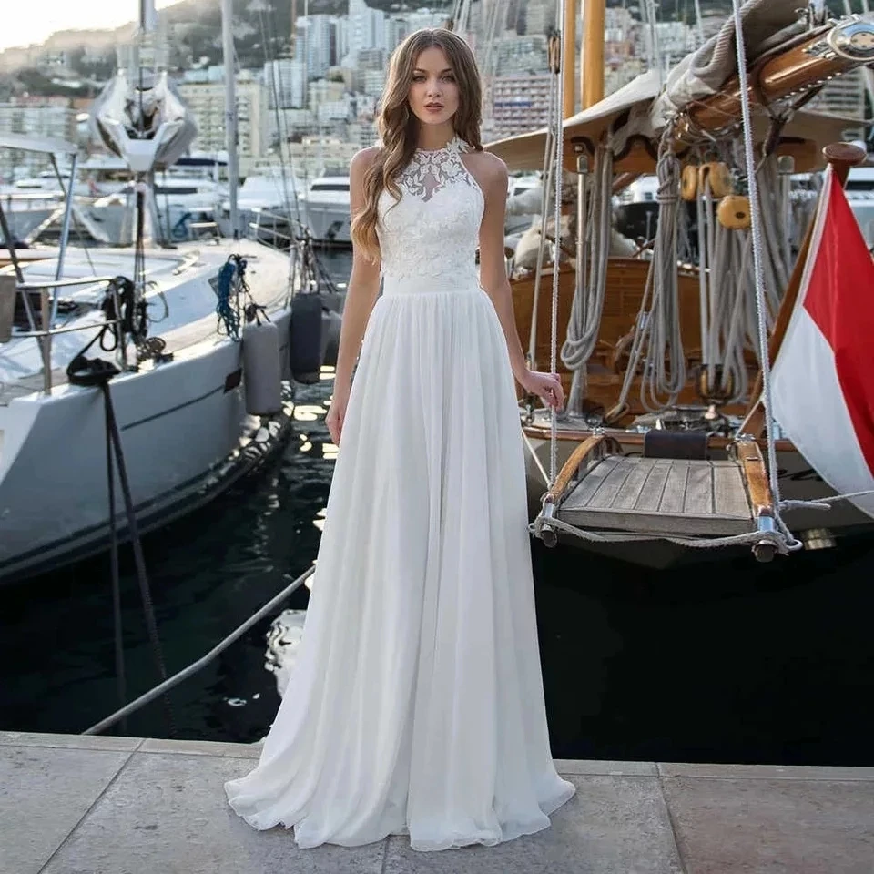 Elegant A-Line Halter Neck Wedding Dress 2022 Boho Sleeveless Lace Appliques Bridal Gown Illusion Backless Button Sweep Train
Elegant A-Line Halter Neck Wedding Dress 2022 Boho Sleeveless Lace Appliques Bridal Gown Illusion Backless Button Sweep Train