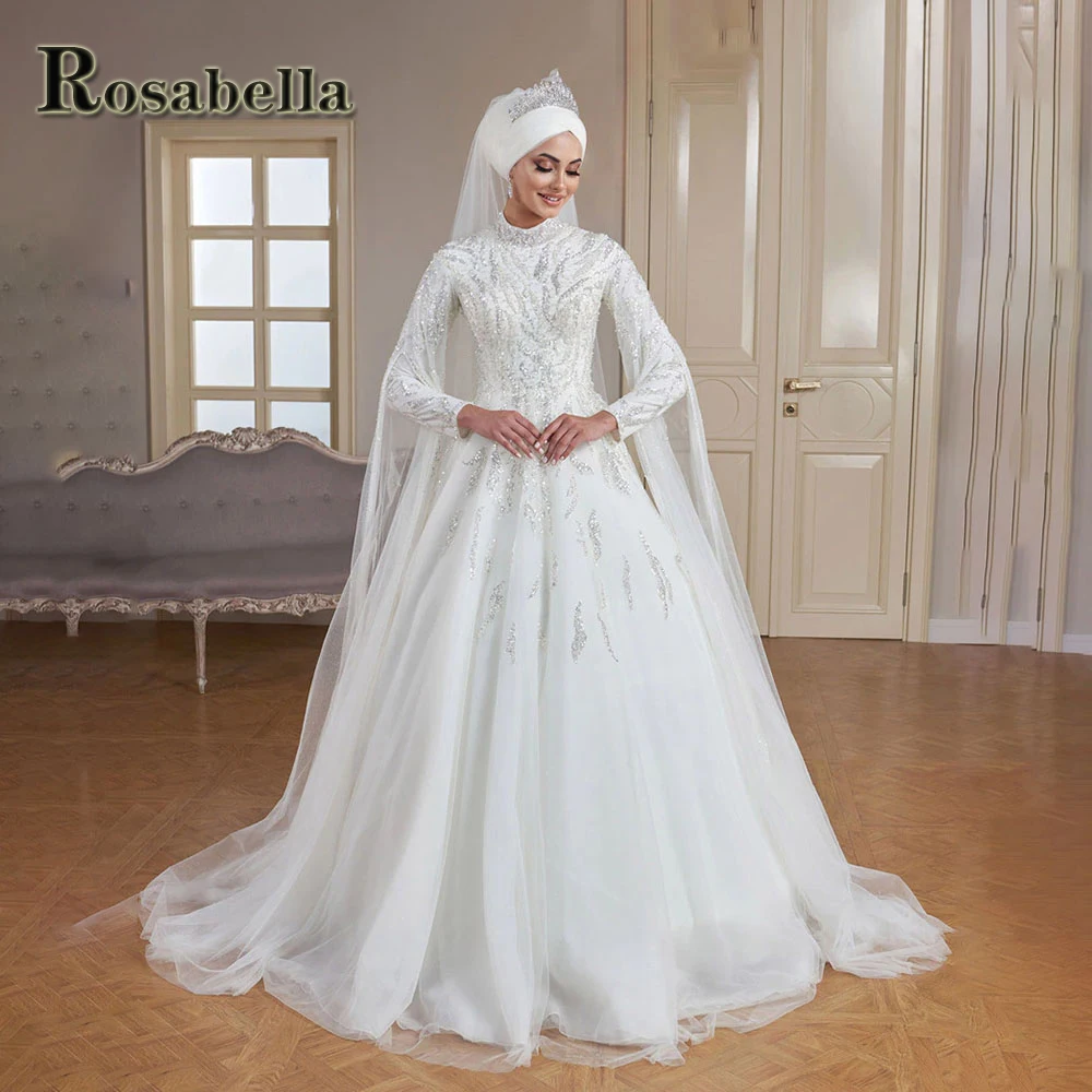 Роскошные блестящие мусульманские свадебные платья ROSABELLA с высоким воротом платья невесты Brautmode Саудовской арабридной невесты индивидуализированные плюс
Роскошные блестящие мусульманские свадебные платья ROSABELLA с высоким воротом платья невесты Brautmode Саудовской арабридной невесты индивидуализированные плюс