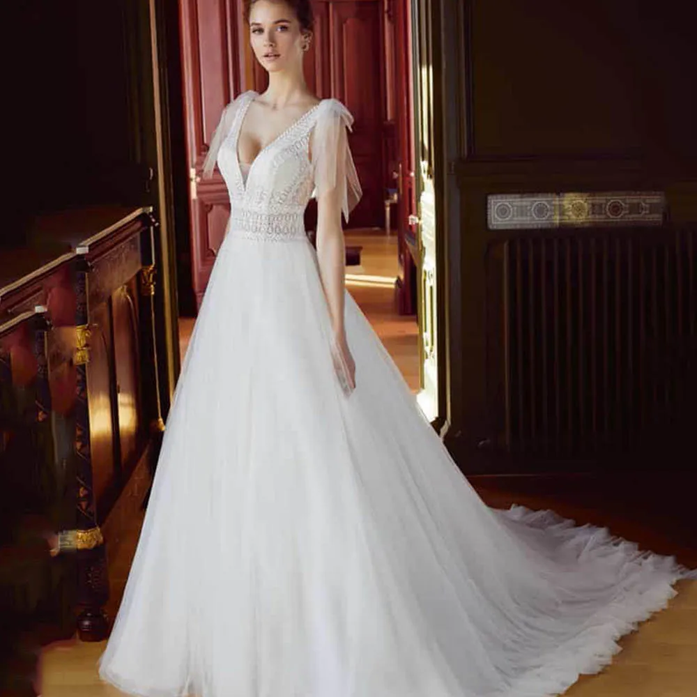 Modern Wedding Dress V-Neck Sleeveless Backless Empire Robe De Mariage 2022 Nouveauté Tulle A-Line Court Train Vestido De Noiva
Modern Wedding Dress V-Neck Sleeveless Backless Empire Robe De Mariage 2022 Nouveauté Tulle A-Line Court Train Vestido De Noiva