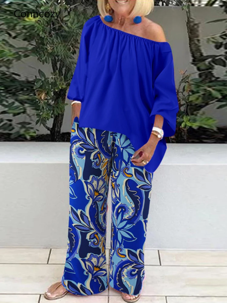 Celmia Pants Sets Fashion One Shoulder 3/4 Sleeve Tops Floral Print Wide Leg Trouser Women Two Piece Sets Casual Loose Suit 2022
Celmia Pants Sets Fashion One Shoulder 3/4 Sleeve Tops Floral Print Wide Leg Trouser Women Two Piece Sets Casual Loose Suit 2022