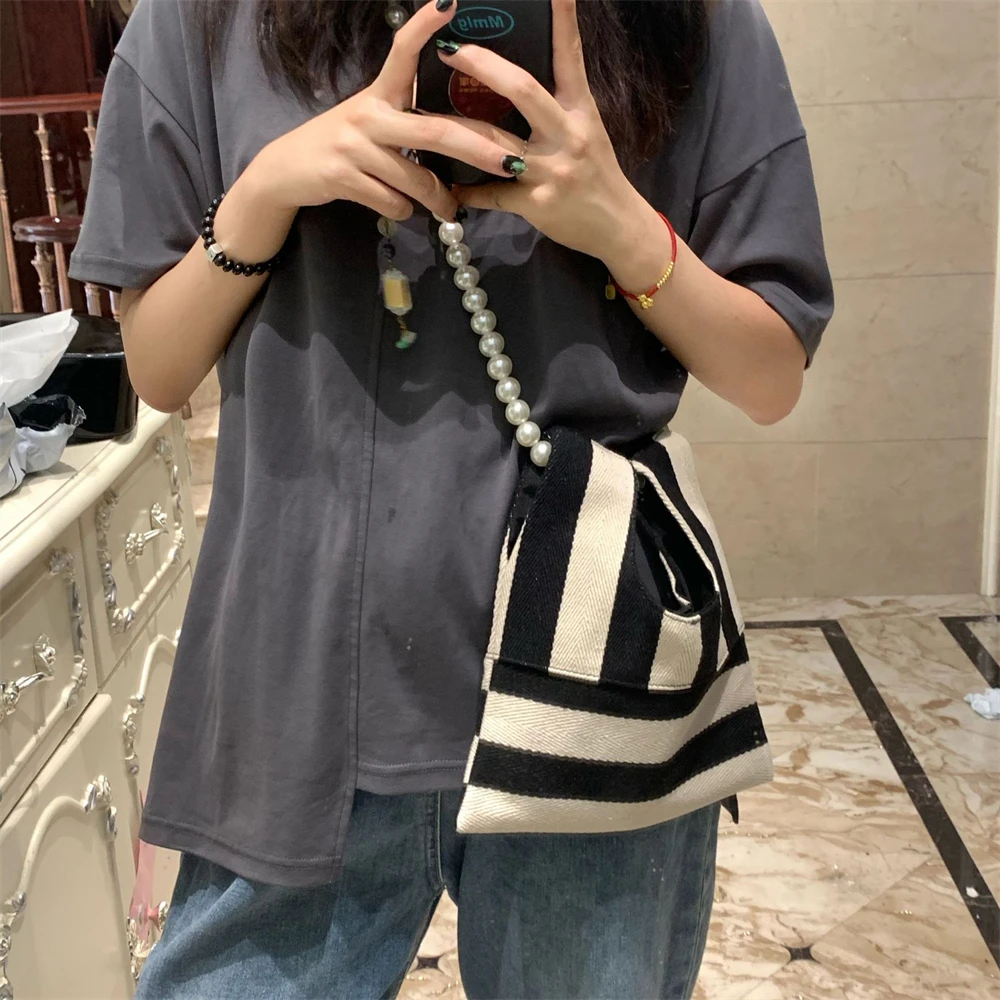 Portable Niche New Pearl Striped Canvas Handbag Hundred Cute Shoulder Cross Mini Small Bag Armpit
Portable Niche New Pearl Striped Canvas Handbag Hundred Cute Shoulder Cross Mini Small Bag Armpit