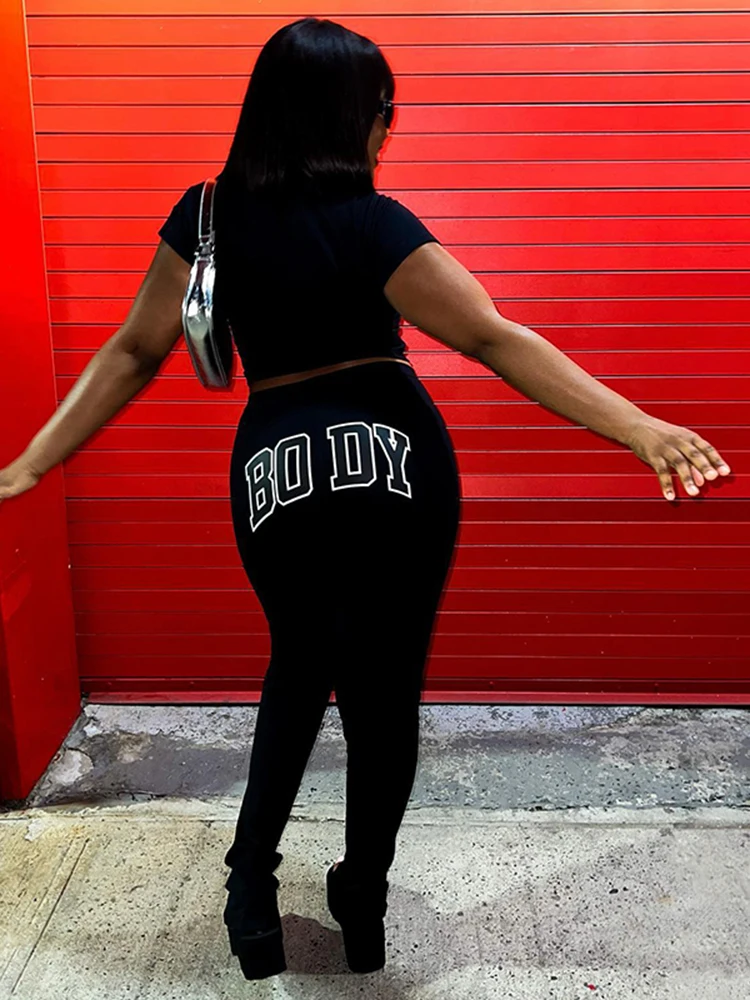YIKUO Solid BODY Letter Print Two Piece Set Women Casual Turn-down Collar Zipper Tops + Hip Lift Slim Pants Street Ladies Suit
YIKUO Solid BODY Letter Print Two Piece Set Women Casual Turn-down Collar Zipper Tops + Hip Lift Slim Pants Street Ladies Suit