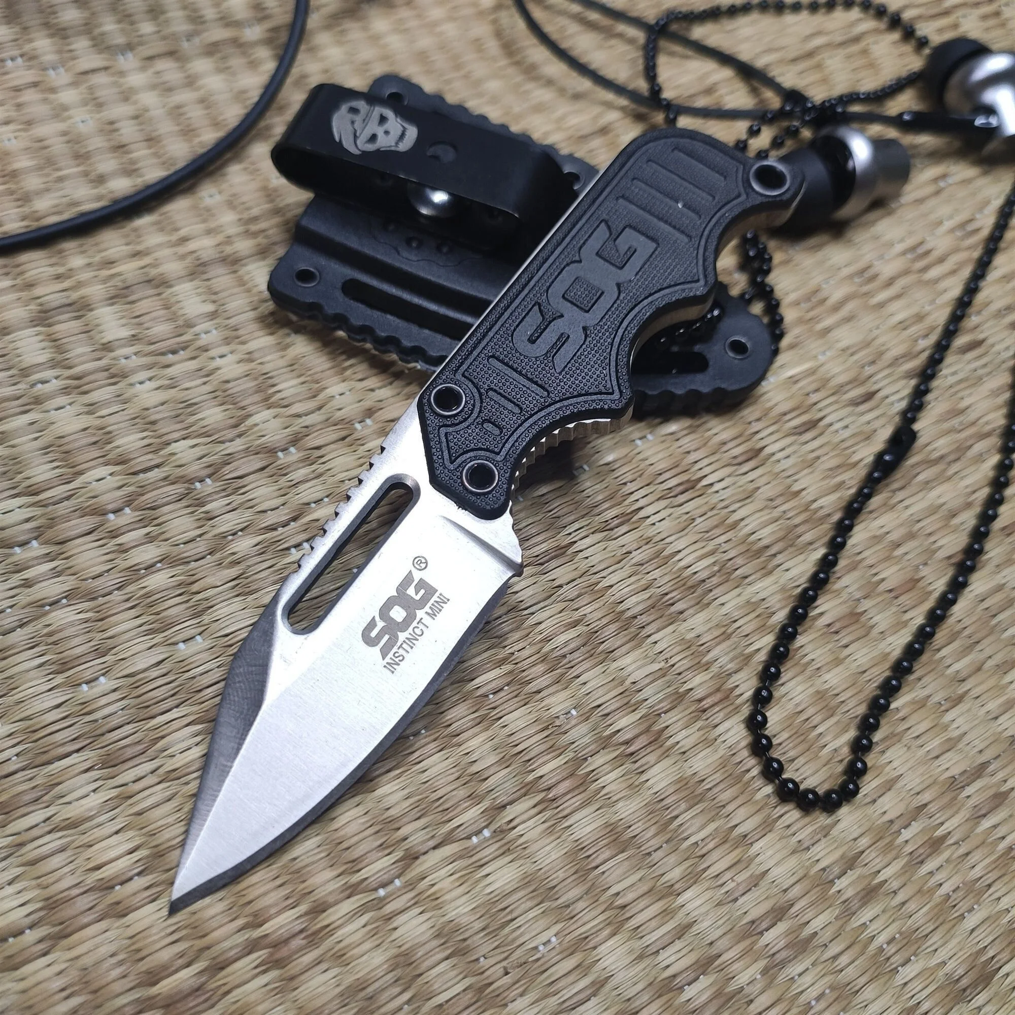 

SOG Pocket EDC Small Fixed Blade Knife - Instinct Mini Neck Knife Satin Plain Blade, G10 Handles with ABS Plastic Sheath