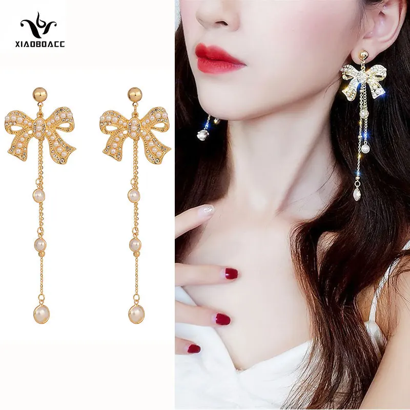 XiaoboACC S925 Silver Needle Bow-knot Pearl Earrings for Women Full Diamond Tassel Ear Jewelry Wholesale
XiaoboACC S925 Silver Needle Bow-knot Pearl Earrings for Women Full Diamond Tassel Ear Jewelry Wholesale