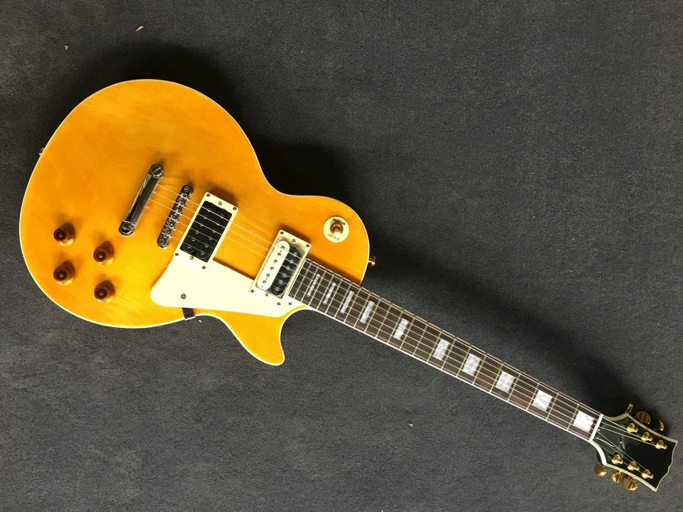 

Yellow six string LP electric guitar, closed pickup, mahogany wood body and neck we can customize various guitars
