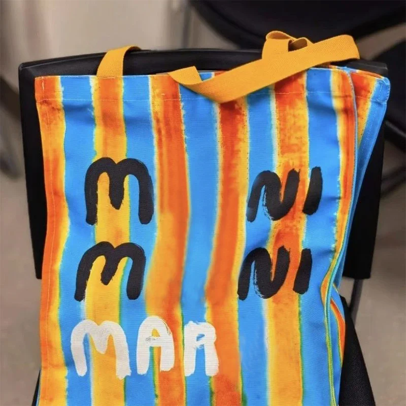 ALEXANDER Shopping Bag Canvas Bag with Hand Gift One Shoulder Handbag Graffiti Letter Fashion Versatile Casual Bag
ALEXANDER Shopping Bag Canvas Bag with Hand Gift One Shoulder Handbag Graffiti Letter Fashion Versatile Casual Bag